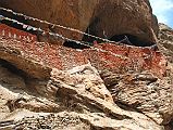 Mustang 02 07-1 Rangbyung Cave Entrance The Rangbyung cave gompa (3450m, also spelled Rangchyung) is built into the side of a cliff with prayer flags strung across the entrance.